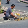 Zdjęcie z Indonezji - Pan rozkladajacy koszyczki ofiarne