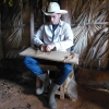 Zdjęcie z Kuby - młody granjero  sięga po liście i prezentuje nam jak zwija się cygaro